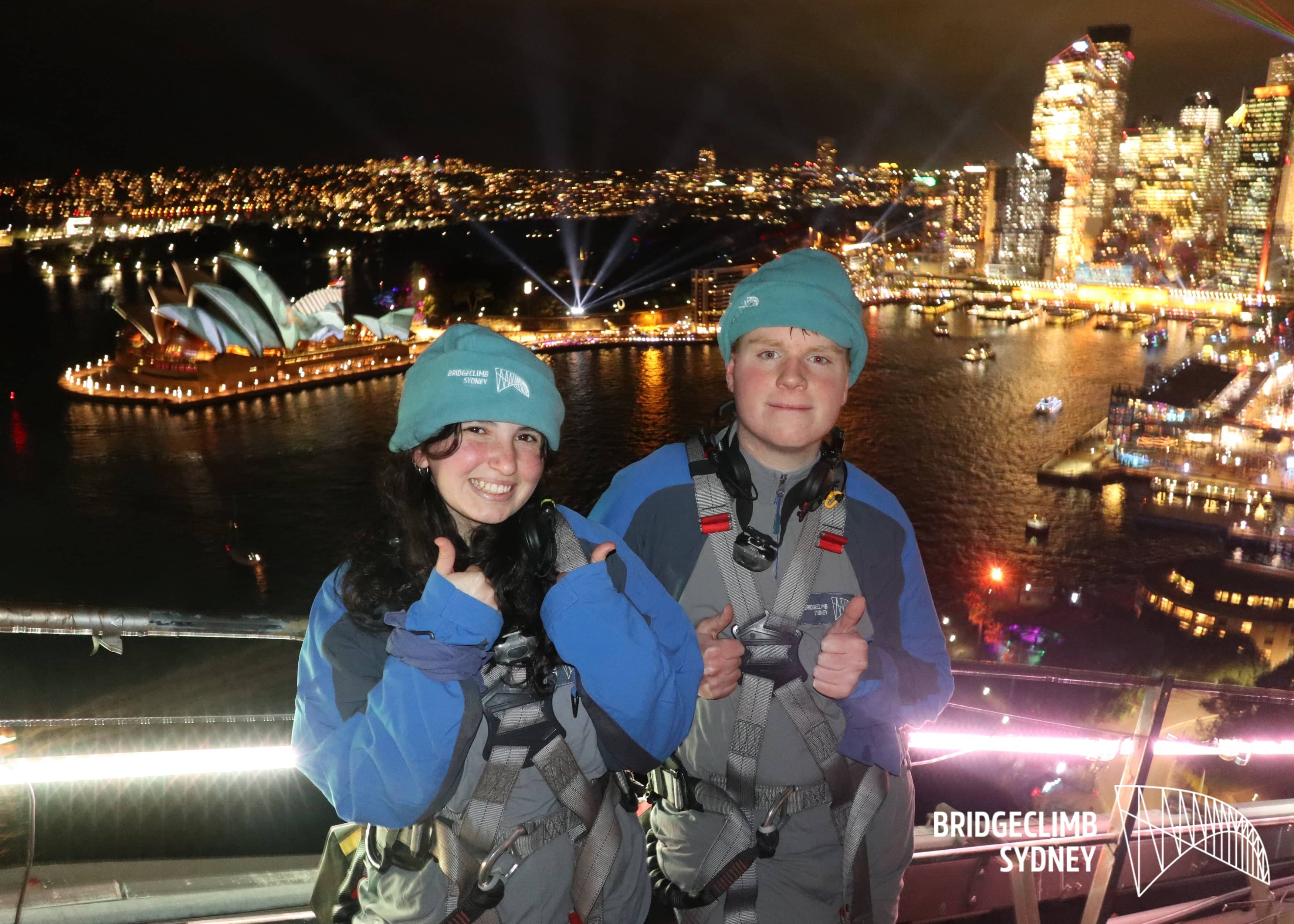 Red-haired male stands on the right side of a frame atop the harbour bridge.